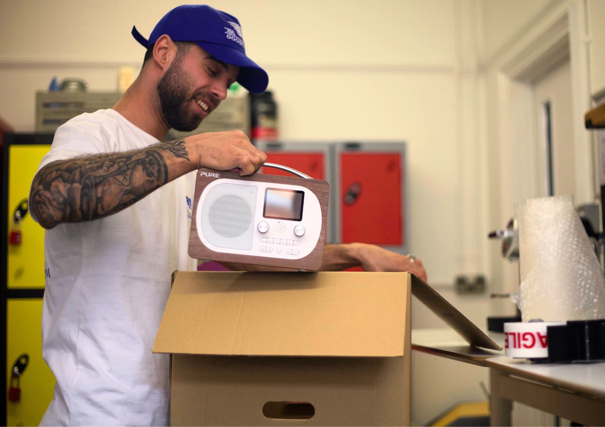 GoodyVan packer preparing a household item inside a moving box